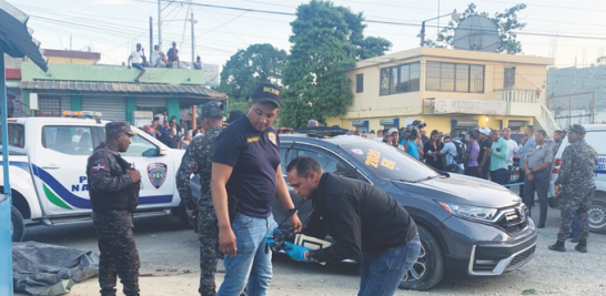 Investigadores de la Policía recogen evidencias en el lugar donde fue tiroteada una Yipeta por dos encapuchados. VÍCTOR RAMÍREZ / LD