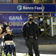 People walk past a branch of Fassil Bank, a day after Bolivia's government took control of the entity following the arrest of four of its executives for alleged mismanagement, in La Paz, on April 27, 2023. (Photo by Aizar RALDES / AFP)