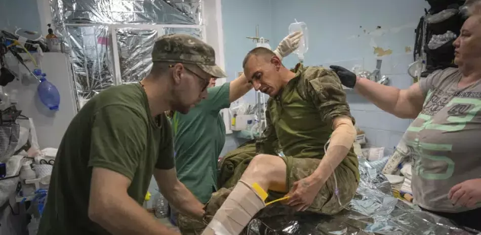 Médicos militares prestan primeros auxilios a soldados ucranianos en un centro de estabilización cerca de Bájmut, en la región de Donetsk, Ucrania, el miércoles 24 de mayo de 2023.